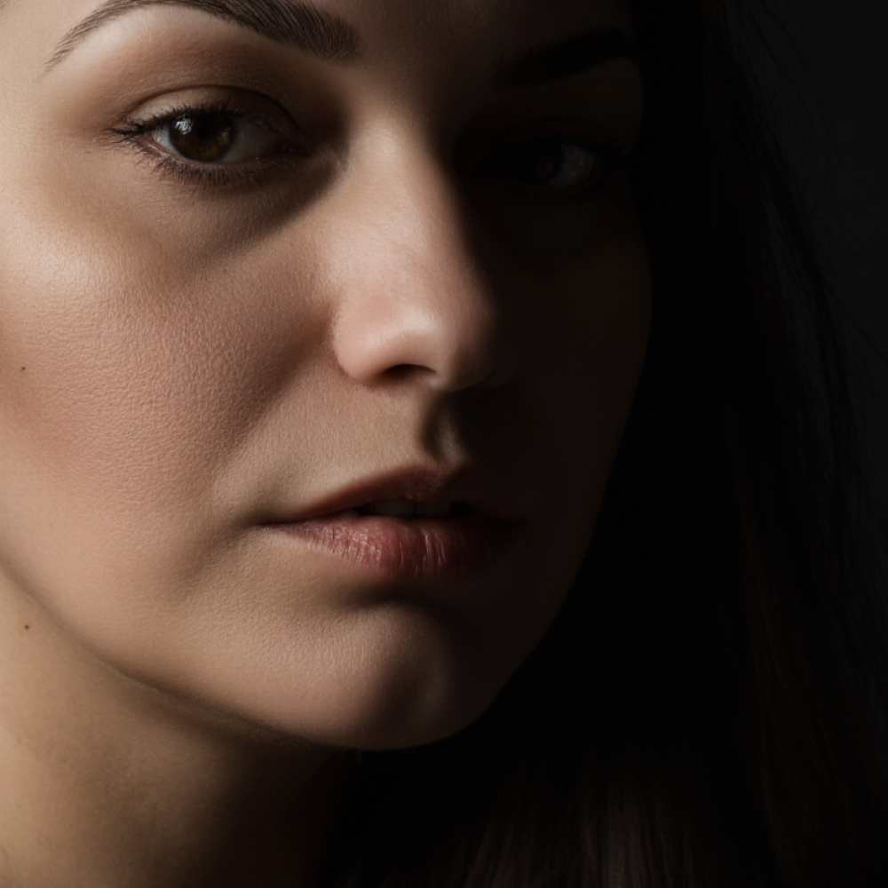 a_beautiful_slightly_curvy_34-year-old_woman_waist-up_portrait_in_low-key_cinematic_lighting_only_pa_d172891d-8987-457c-b3e6-4d73fa3e1f64